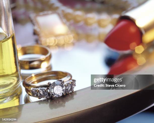 a diamond ring on the edge of a table - taking off wedding ring stock pictures, royalty-free photos & images