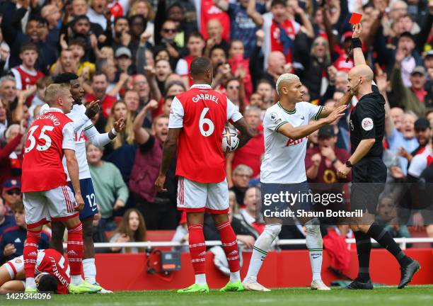 Richarlison of Tottenham Hotspur reacts as match referee Anthony Taylor shows a red card to Emerson Royal of Tottenham Hotspur during the Premier...