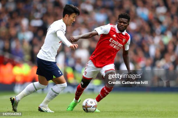 Son Heung-Min of Tottenham Hotspur is challenged by Thomas Partey of Arsenal during the Premier League match between Arsenal FC and Tottenham Hotspur...