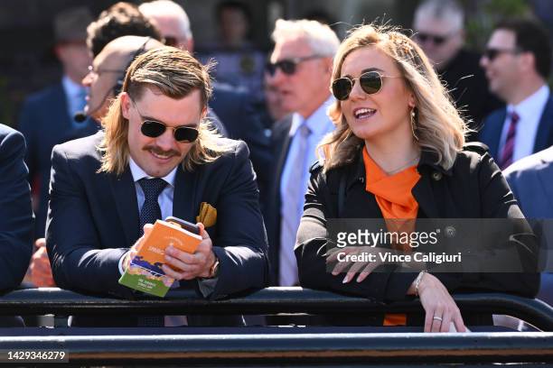 Australian swimmer, Ariarne Titmus and Kyle Niesler are seen during Turnbull Stakes Day at Flemington Racecourse on October 01, 2022 in Melbourne,...