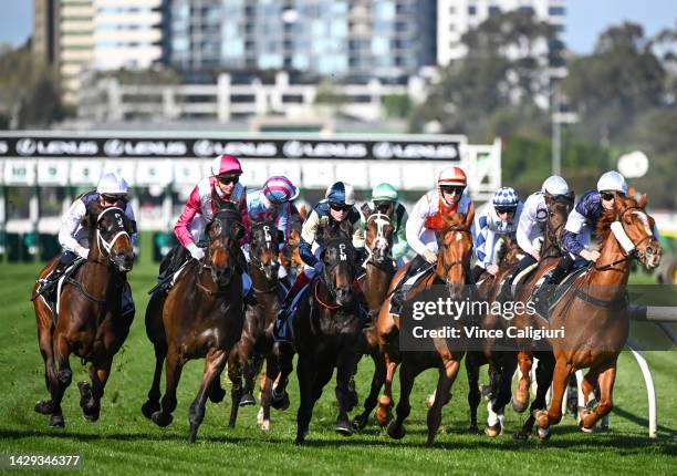 The field race to the first turn in Race 6, the The Lexus Bart Cummings, during Turnbull Stakes Day at Flemington Racecourse on October 01, 2022 in...