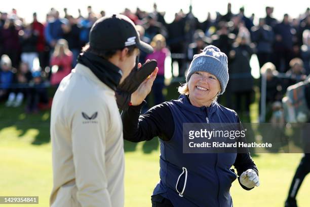 Matthew Fitzpatrick of England congratulates their mother Susan Fitzpatrick after teeing off on the 11th hole on Day Three of the Alfred Dunhill...