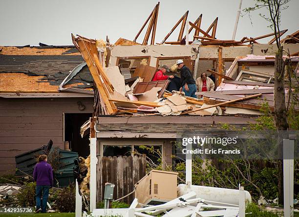 Galen Zumbach of Creston, Iowa begins the cleanup process with the help of neighbors and friends after his house was hit by a tornado April 15, 2012...