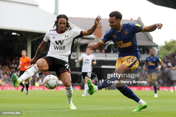 Jacob Murphy of Newcastle United is challenged by Kevin Mbabu of Fulham during the Premier League match between Fulham FC and Newcastle United at...