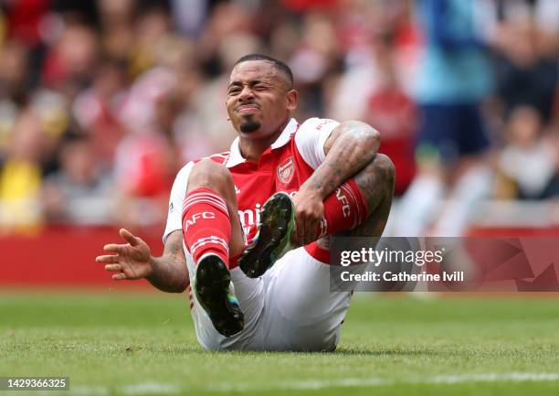 Gabriel Jesus of Arsenal holds his ankle before being treated for an injury during the Premier League match between Arsenal FC and Tottenham Hotspur...