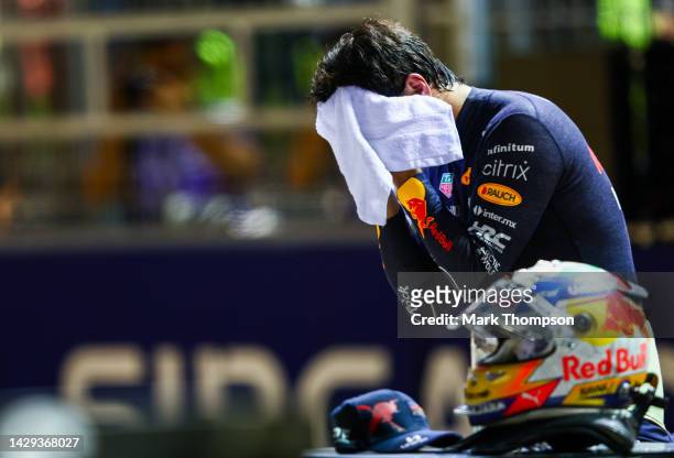 Second placed qualifier Sergio Perez of Mexico and Oracle Red Bull Racing wipes his face in parc ferme during qualifying ahead of the F1 Grand Prix...