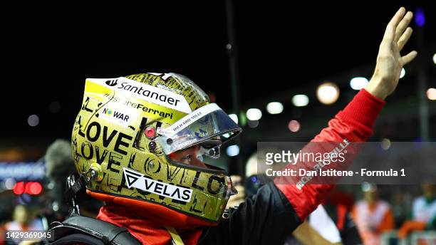 Pole position qualifier Charles Leclerc of Monaco and Ferrari waves to the crowd from parc ferme during qualifying ahead of the F1 Grand Prix of...
