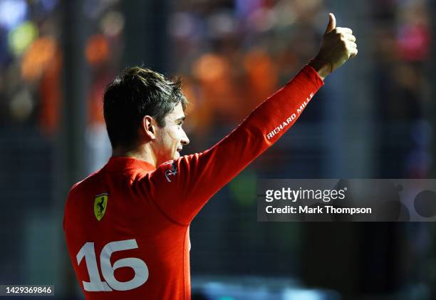 Pole position qualifier Charles Leclerc of Monaco and Ferrari celebrates in parc ferme during qualifying ahead of the F1 Grand Prix of Singapore at...