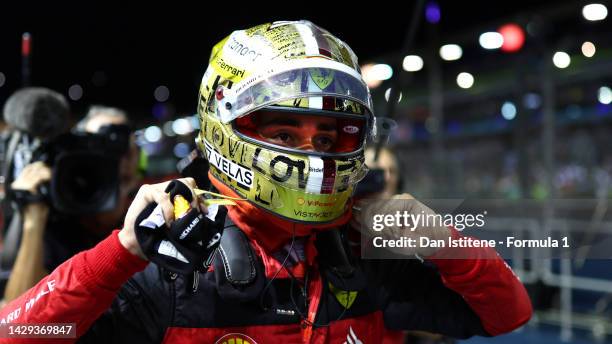 Pole position qualifier Charles Leclerc of Monaco and Ferrari celebrates in parc ferme during qualifying ahead of the F1 Grand Prix of Singapore at...