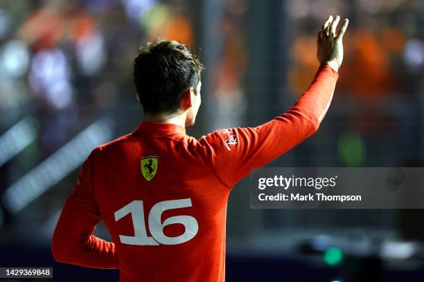 Pole position qualifier Charles Leclerc of Monaco and Ferrari celebrates in parc ferme during qualifying ahead of the F1 Grand Prix of Singapore at...