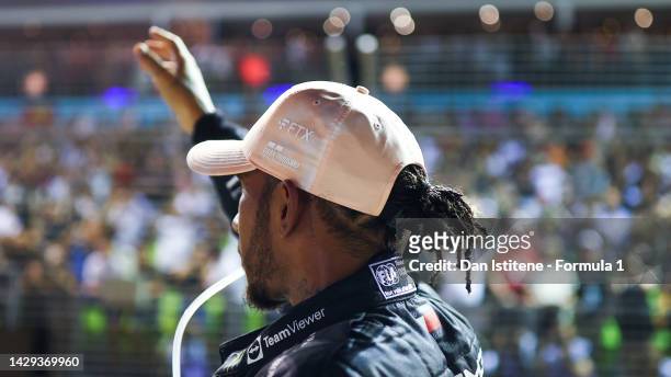 Third placed qualifier Lewis Hamilton of Great Britain and Mercedes waves to the crowd in parc ferme during qualifying ahead of the F1 Grand Prix of...