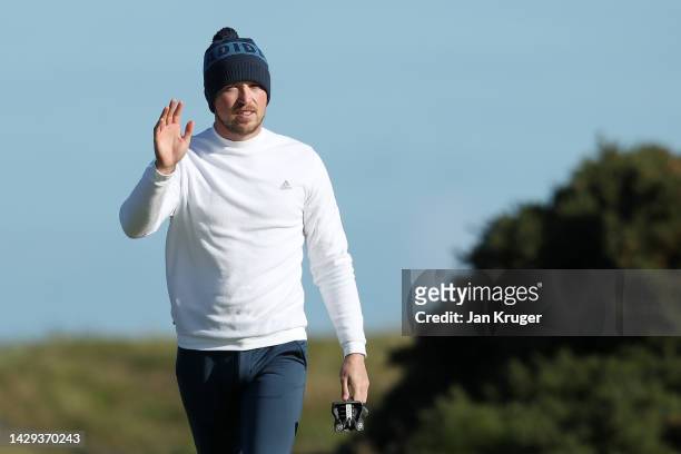 Richard Mansell of England acknowledges spectators after their putt on the 17th green on Day Three of the Alfred Dunhill Links Championship at...
