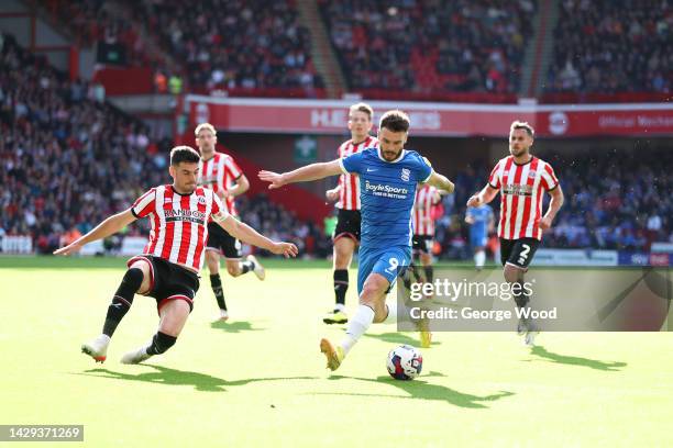 Scott Hogan of Birmingham City runs with the ball whilst under pressure from John Egan of Sheffield United during the Sky Bet Championship between...