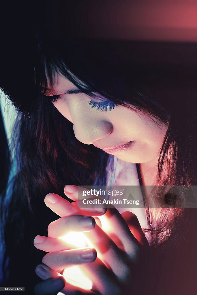 Woman with light in hands