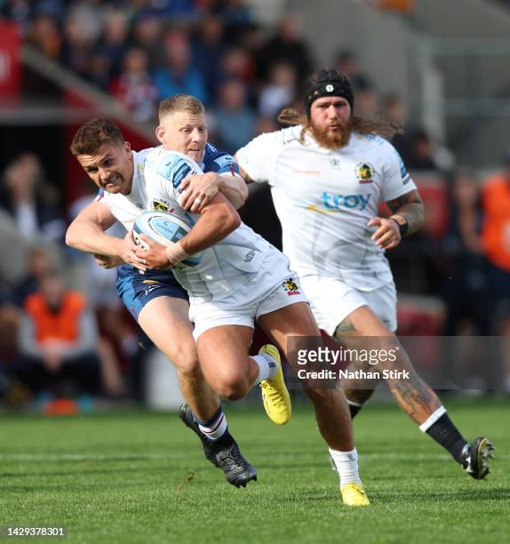 Henry Slade of Exeter Chiefs is tackled by Robert du Preez of Sale Sharks during the Gallagher Premiership Rugby match between Sale Sharks and Exeter...