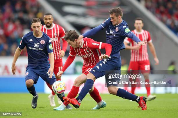 Michael Gregoritsch of SC Freiburg battles for possession with Stefan Bell of FSV Mainz during the Bundesliga match between Sport-Club Freiburg and...