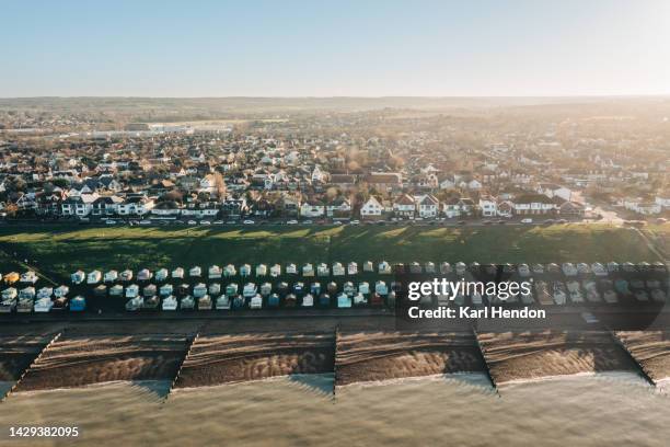 an elevated daytime view of beach huts and a town on the english coast - kent england stockfoto's en -beelden