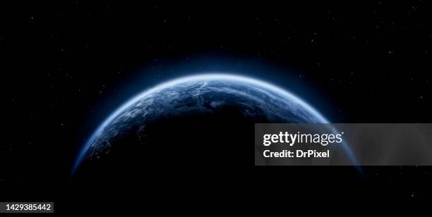 planet earth with clouds and dark space with stars - copyspace stockfoto's en -beelden