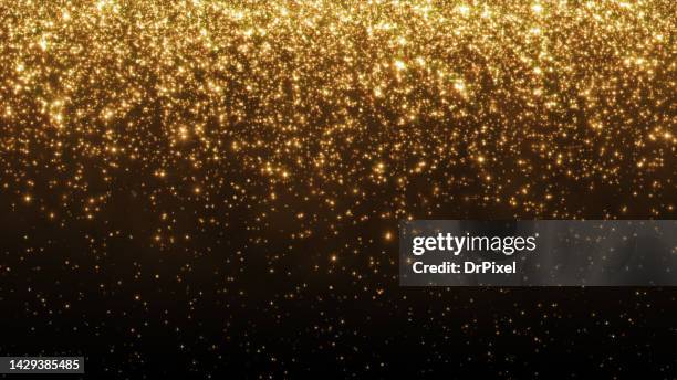 glittering golden particles - glitter stockfoto's en -beelden