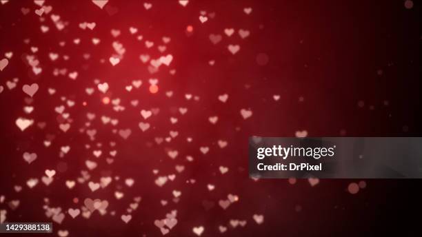 glowing hearts on red gradient background - heart bokeh stock pictures, royalty-free photos & images
