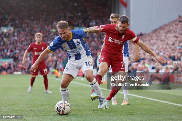 Alexis Mac Allister of Brighton & Hove Albion is challenged by James Milner of Liverpool during the Premier League match between Liverpool FC and...