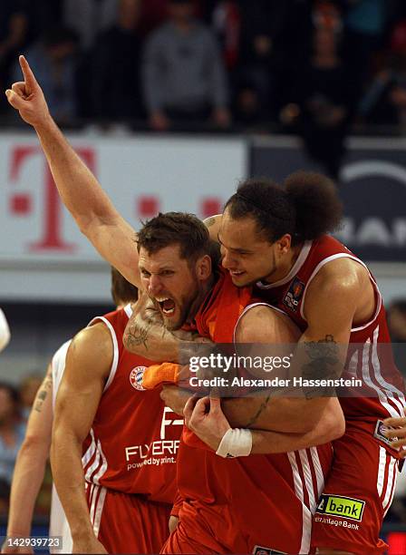 Chevon Troutman of Muenchen celebrates victory with his team mate Jared Homan after winning the Beko Basketball match between FC Bayern Muenchen and...