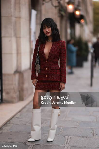 Jihoon Kim seen wearing a red blazer, red skirt and white leather boots and a small handbag outside Alessandra Rich during Pariser Fashion Week on...