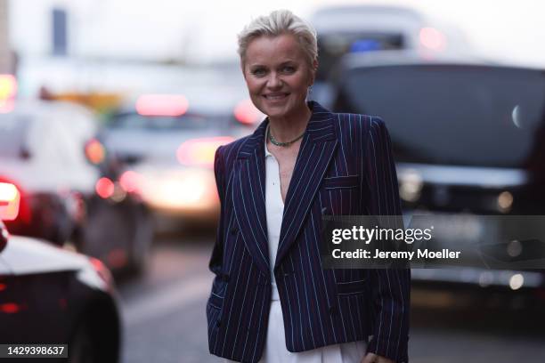 Barbara Sturm seen wearing a black Hermes mini Kelly bag, blue and white blazer, white suit and white boots outside Alessandra Rich during Pariser...