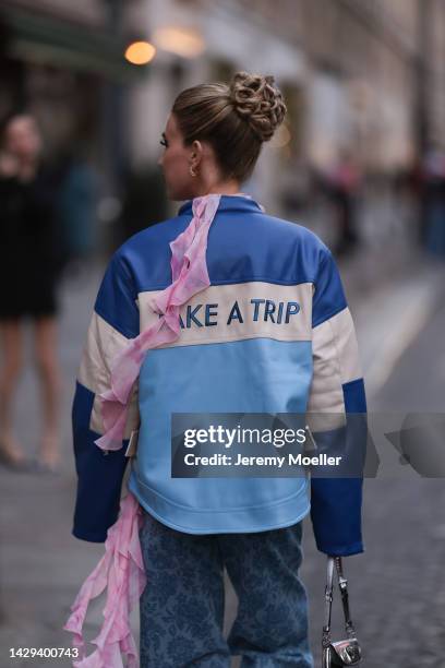 Emili Sindlev seen wearing a blue and white jacket, rose blouse and blue denim pants and a Prada silver shiny Cleo bag outside Alessandra Rich during...