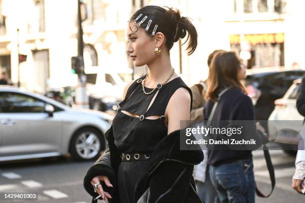 Guest is seen wearing a black cut out top, black pants, black pebble bag and silver hair clips outside the Loewe show during Paris Fashion Week S/S...