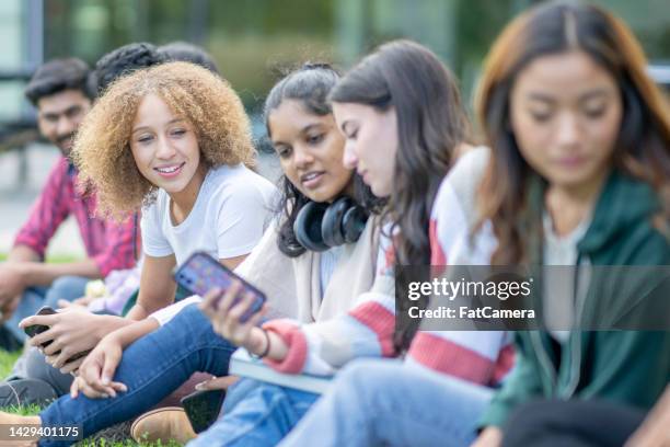 university students catching up on social media - media literacy stock pictures, royalty-free photos & images