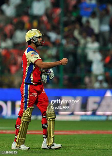 Royal Challengers Bangalore batsman Virat Kholi pumps his fist with dissatisfaction as he walks back to the pavilion after being bowled out by...