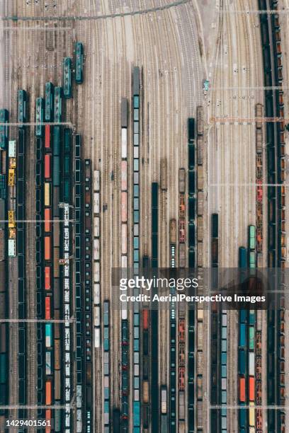 aerial view of freight trains and railroad station - lokomotive stock-fotos und bilder