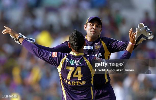 Kolkata Knight Riders bowler Sunil Naraine celebrating with teammate Manvinder Bisla after dismissal of Kings XI Punjab batsman Adam Gilchrist during...