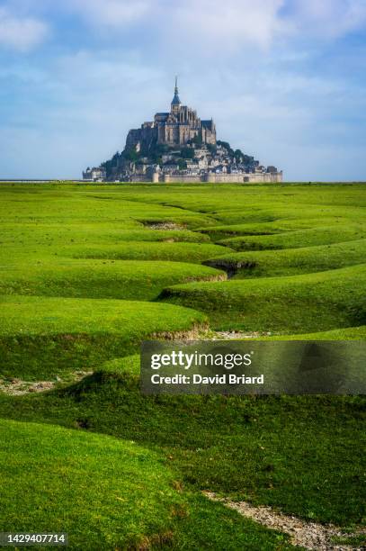 mont saint-michel in green and blue - mont saint michel stock pictures, royalty-free photos & images