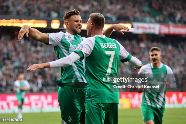 Niclas Fullkrug of Werder Bremen celebrates with teammate Marvin Ducksch after scoring their team's third goal during the Bundesliga match between SV...