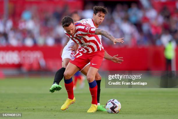 Saul Niguez of Atletico de Madrid is challenged by Oliver Torres of Sevilla FC during the LaLiga Santander match between Sevilla FC and Atletico de...