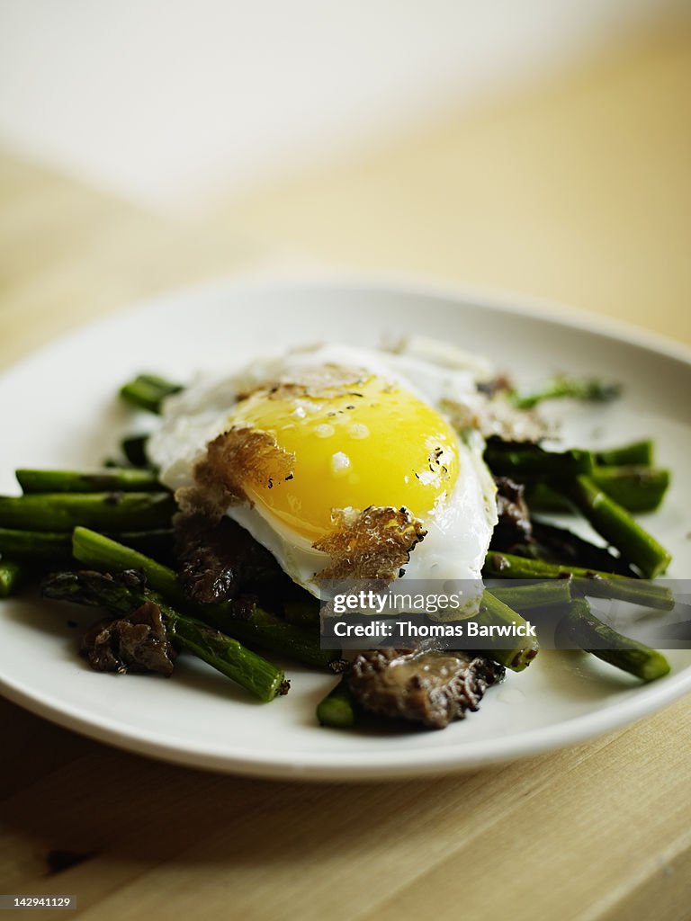 Grilled asparagus and morels topped with egg