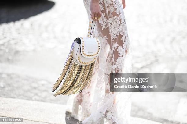 Miki Cheung is seen wearing white sheer floral skirt and white and gold chain fringed bag outside the Giambattista Valli show during Paris Fashion...