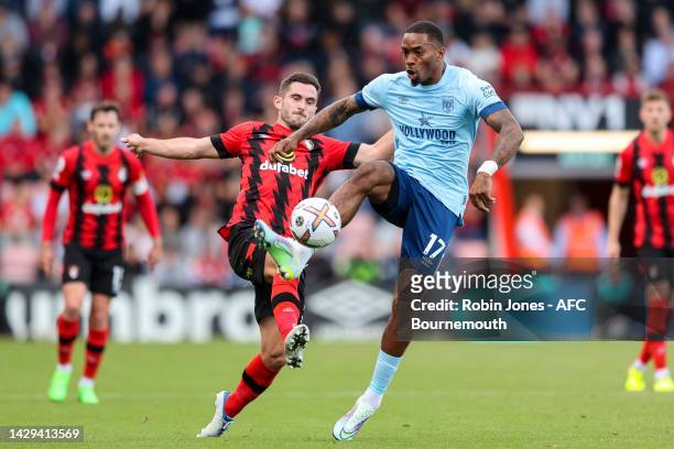 Ivan Toney of Brentford clears from Lewis Cook of Bournemouth during the Premier League match between AFC Bournemouth and Brentford FC at Vitality...