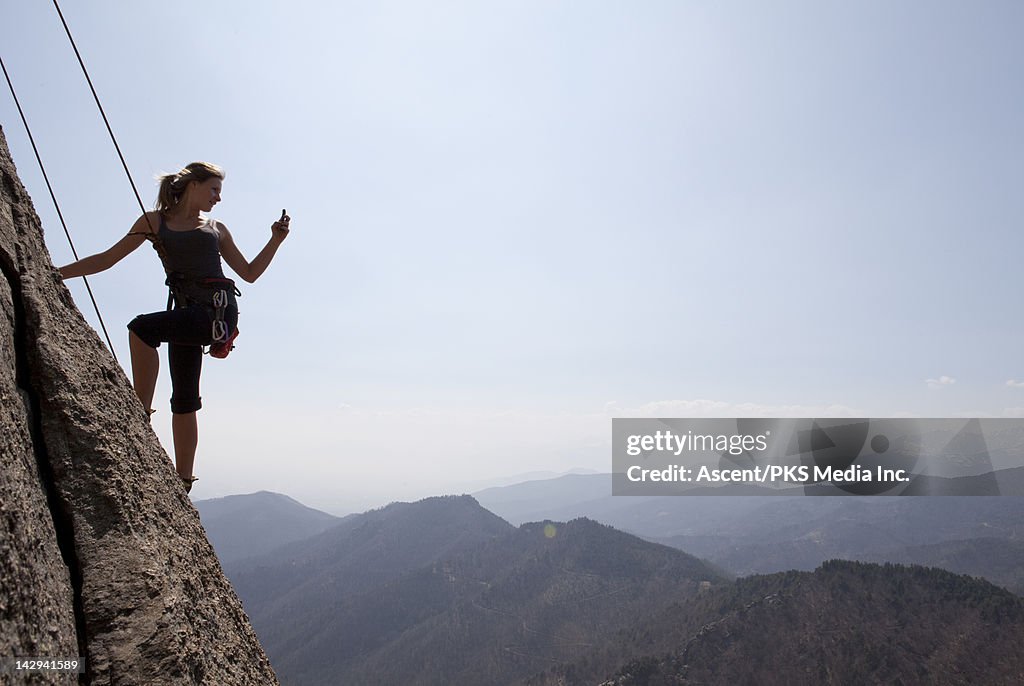 Teenage climber stops on route to take picture