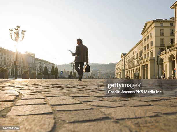 businessman consults digital tablet,crosses piazza - cobblestone texture stock pictures, royalty-free photos & images