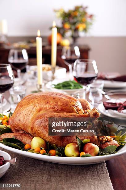 turkey dish on table set with wine and candles - turkey cooked stock-fotos und bilder