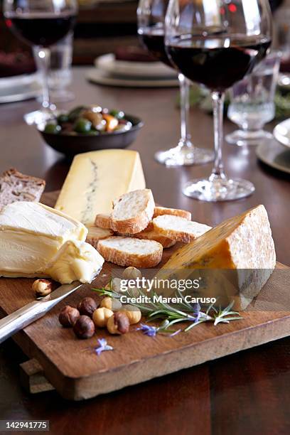 cheese and bread dish, wine, olives, on table - cheese and wine stock-fotos und bilder