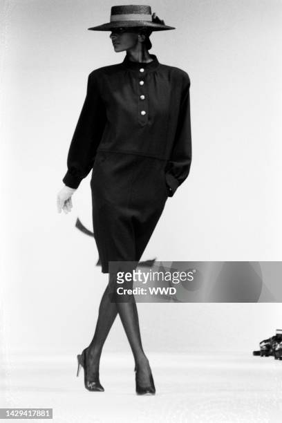 Model Gloria Burgess on the runway in a Chemise dress from Yves Saint Laurent's spring 1984 ready to wear collection.