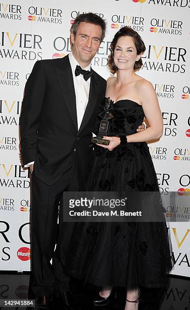 Presenter Jack Davenport and Best Actress winner Ruth Wilson pose in the press room at the 2012 Olivier Awards held at The Royal Opera House on April...