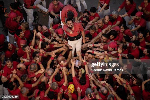 Members of the colla 'Castellers de l'alt Maresme' celebrate after building a human tower during the 28th Tarragona Competition on October 1, 2022 in...