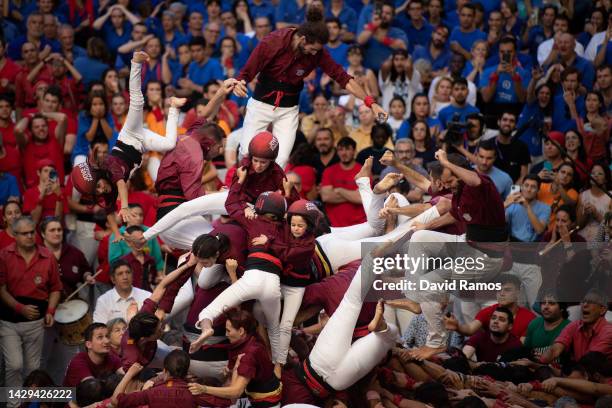 Members of the colla 'Jove de Barcelona' fall down as they build a human tower during the 28th Tarragona Competition on October 1, 2022 in Tarragona,...