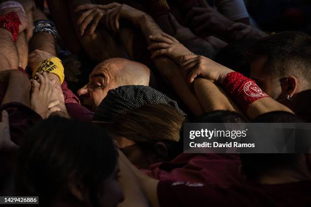 Members of the colla 'Jove de Barcelona' fall down as they build a human tower during the 28th Tarragona Competition on October 1, 2022 in Tarragona,...