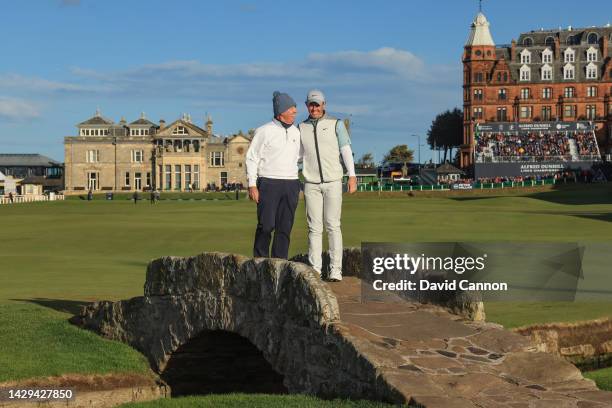 Rory McIlory of Northern Ireland and his father Gerry McIlroy pose for a photograph on the Swilcan Bridge on the 18th hole on Day Three of the Alfred...